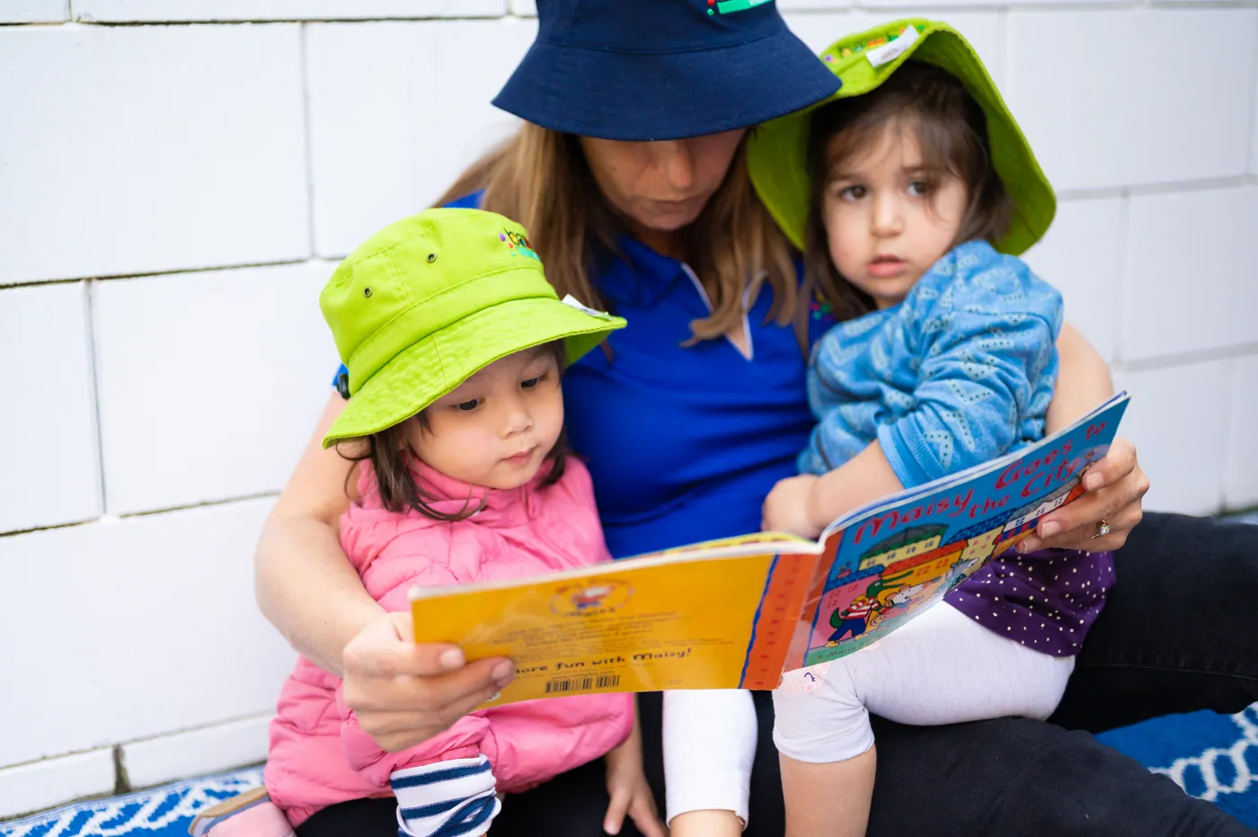 An educator reading quietly with a toddler
