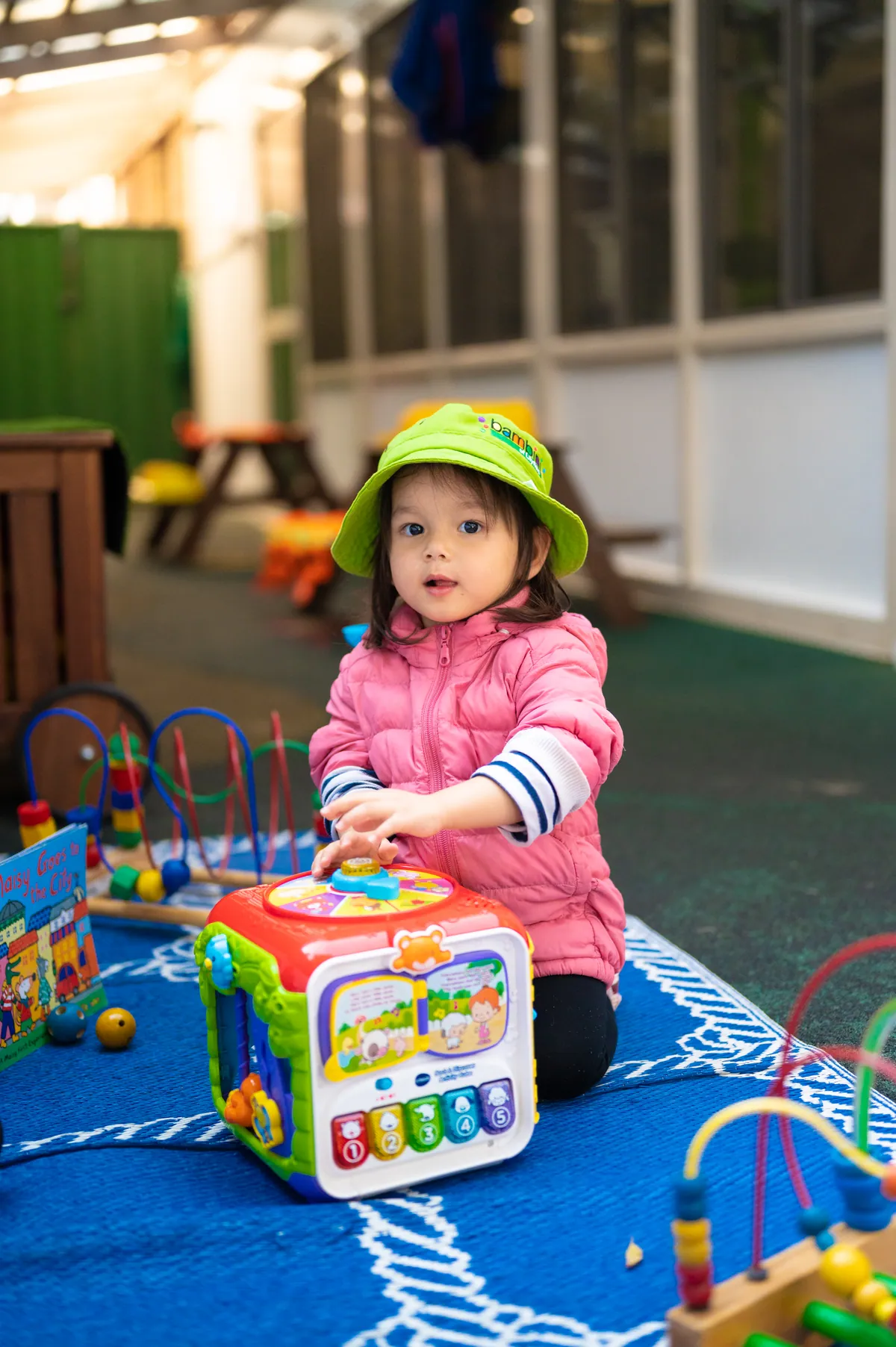 A baby exploring an activity table in the Piccolini room